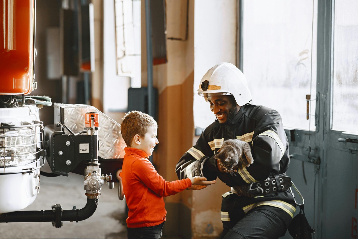 Firefighter, child, and kitten